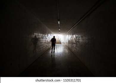 A runner' silhoutte on the dark tunnel runs to light - Powered by Shutterstock