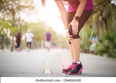 Runner Sport Knee Injury. Woman In Knee Pain While Running Work Out In Park. Health Care Concept.