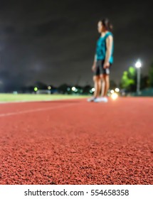 A runner is standing at track running