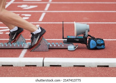 Runner starting from  starting block on stadium track for sprint 400 meter run detail on legs close up photography