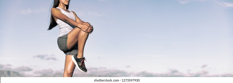 Runner Stretching Legs Hamstring Muscles Outdoor Holding One Leg Standing Outdoor In Sky Background Banner Panorama. Running Athlete Woman Doing Fitness Stretch.