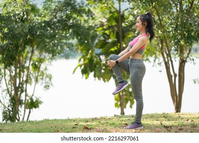 Runner Stretching Legs And Hamstring Muscles Outdoors Holding One Leg Standing Outdoor