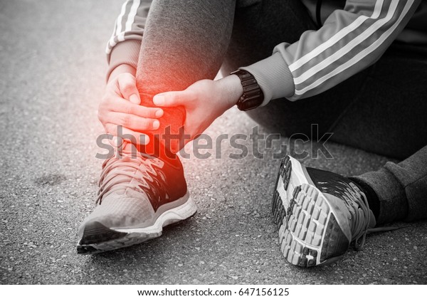 Runner touching painful twisted or broken ankle.\
Athlete runner training accident. Sport running ankle sprained\
sprain cause injury.