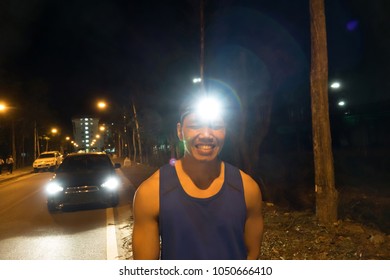 Runner Wearing Headlamp With Light Flares,Night Runing Safety Concept.