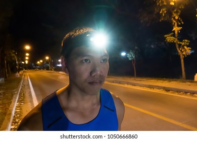 Runner Wearing Headlamp With Light Flares,Night Runing Safety Concept.