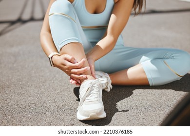 Runner woman and ankle injury pain rest on outdoor sidewalk floor for physical pressure relief. Injured fitness girl with inflammation from running exercise resting legs for tension in joint. - Powered by Shutterstock