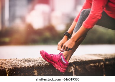 Runner Woman Getting Ready To Run Tying Running Shoes Laces. Healthy Lifestyle Jogging Motivation Closeup Of Feet Or Footwear.