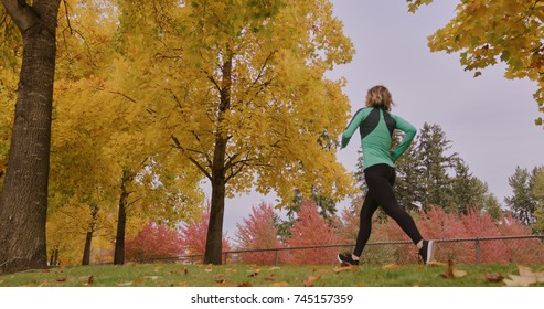 Runner Woman Running In Park Exercising Outdoors Power Walk