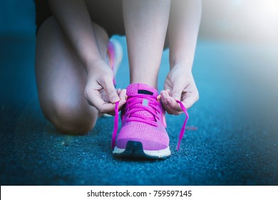 Runner Woman Tying Running Shoes Laces Getting Ready For Race On Run Track 