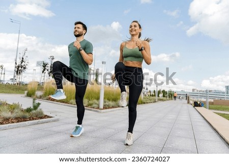 Runners athletes in fitness clothes. Motivation for the doric lifestyle. Beautiful jogging in sports shoes. Cardio endurance exercises, use a fitness watch and an app.