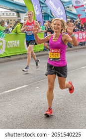 Runners Completing The 41st London Marathon Running Over Tower Bridge. London - 3rd October 2021