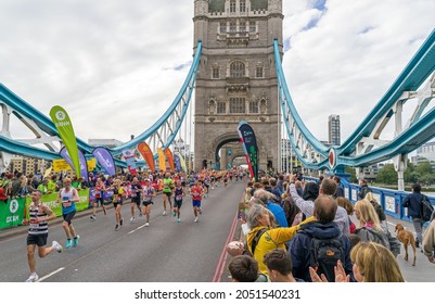 Runners Completing The 41st London Marathon Running Over Tower Bridge. London - 3rd October 2021