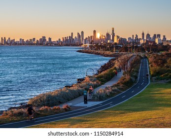 Runners and cyclists enjoying the sunset from Ormond point in Melbourne, Australia
