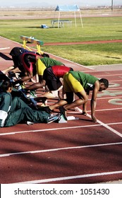 Runners Get Set For The Start Of The  Men's 100 Yard Dash At A College Track Meet.