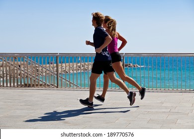 Runners On The Beach. Urban Scene.