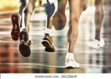 Runners on wet ground with city reflection - Powered by Shutterstock