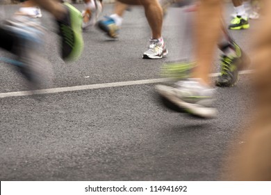 Runners Running In City Marathon, Motion Blur On Sporty Legs