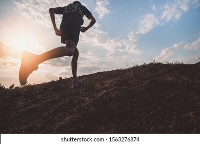 Runners running fitness in woods.athlete running on trail stones. - Shutterstock ID 1563276874