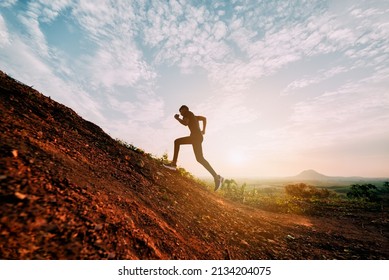 Runners running fitness in woods.athlete running on trail stones in forest. - Powered by Shutterstock