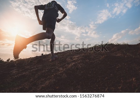 Runners running fitness in woods.athlete running on trail stones.