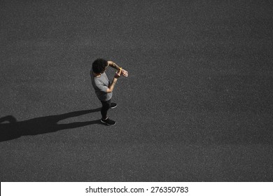 Runners training - young multiracial couple running exercising concentrated on road. Caucasian fitness model man checking time or pulse on heart rate monitor watch. - Powered by Shutterstock