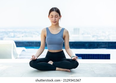 Running Asian woman. Female Runner Jogging during Outdoor Workout in a Park. Asian woman running in garden. Her morning exercise.Young Asian Girl doing yoga at rooftop. - Powered by Shutterstock