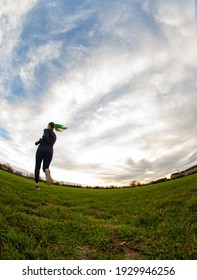 Running Athlete Girl On Grass With Sky Background Taken With Fisheye Lens