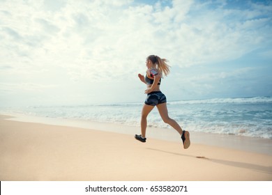 Running Athlete On The Beach