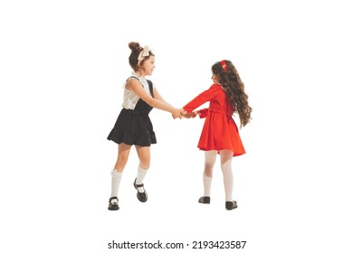 Running Away. Studio Shot Of Little Happy Girls In Retro Style Outfit, Fashion Of 70s, 80s Years Isolated On White Background. Concept Of Emotions, Facial Expression, Beauty. Copy Space For Ad