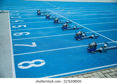 Running background. Start line with big numbers, athletics track and starting blocks. Blue colors - Powered by Shutterstock