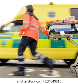 Running Blurry Paramedic Woman Rolling Stretcher Outside Of Ambulance Car