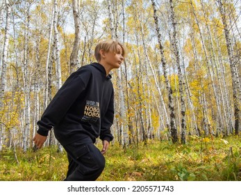 Running Boy. Running Teen In The Autumn Park. The Guy Is Training In The Park. Forest Trail Training. Russia, Irkutsk, September 17, 2022