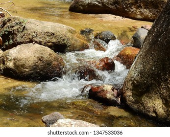 A Running Brook Or Stream Among The Boulders