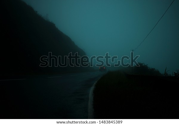 Running Car in Foggy Clouds in\
Roads to Dawki from Shillong in Northeastern Indian State of\
Meghalaya