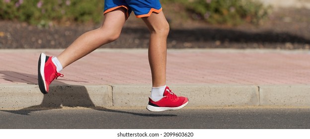 Running Child, Young Athlete Run In A Kid Run Race, Running On City Road Detail On Legs,running In The Light Of Morning