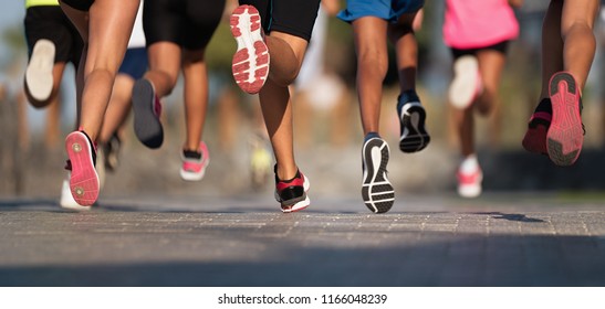 Running Children, Young Athletes Run In A Kids Run Race,running On City Road Detail On Legs,running In The Light Of Morning