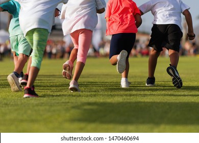 Running Children, Young Athletes Run In A Kids Run Race, Running On Grass Detail On Legs, Running In The Light Of Morning