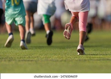 Running Children, Young Athletes Run In A Kids Run Race, Running On Grass Detail On Legs, Running In The Light Of Morning