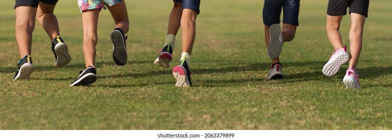 Running Children, Young Athletes Run In A Kids Run Race, Running On Grass Detail On Legs, Running In The Light Of Morning