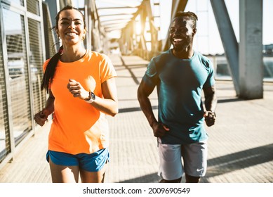 Running Couple Jogging Training Outside On Run - Black Man And Caucasian Woman Runner And Fitness Sport On City Street - Exercising, Jogging And Sport Concept