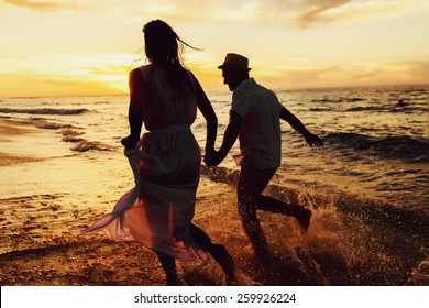 Running Couple On The Beach