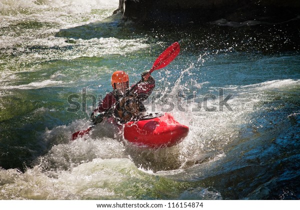 Running the\
dangerous mountain river in a\
kayak.