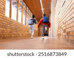 Running down school hallway, multiracial boy and girl with backpacks heading to classroom. education, students, childhood, movement, learning, excitement