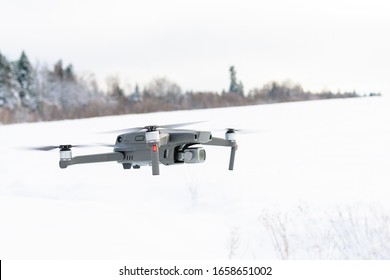 Running drone into the sky, quadcopter on blue sky background.