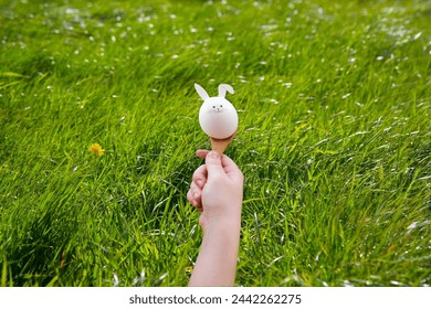 Running with easter egg in spoon. Easter rabbit
