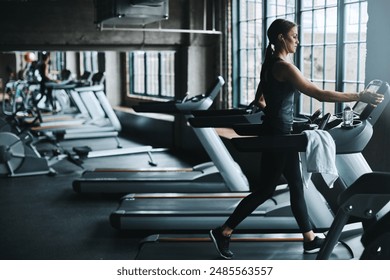 Running, exercise and woman on treadmill in gym listening to music, audio and radio for cardio workout. Sports, wellness and person with earphones for fitness, marathon training and practice for race - Powered by Shutterstock