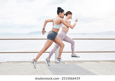 Running, fitness and fast women doing sprint challenge by ocean, sea promenade or beach for outdoor wellness, exercise or cardio workout. Sports athlete people train for speed and a healthy lifestyle - Powered by Shutterstock