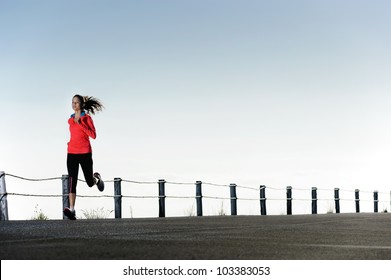 Running fitness training woman outdoors. Action healthy lifestyle image with copyspace - Powered by Shutterstock