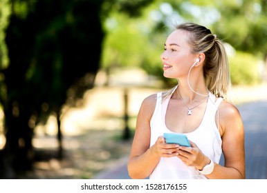 Running girl, with blond hair, jogging listens to music in park. Woman summer fitness workout. Jogging, sport, healthy active lifestyle concept - Shutterstock ID 1528176155
