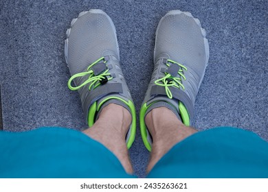 Running grey barefoot shoes, close up. Man wearing barefoot shoes.